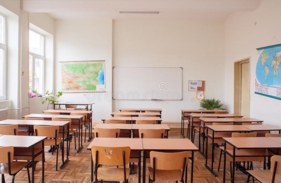 empty-classroom-interior-wooden-desks-chairs-maps-white-board-52354235